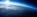 Die Erdoberfläche aus dem Weltraum mit der Sonne am Horizont.